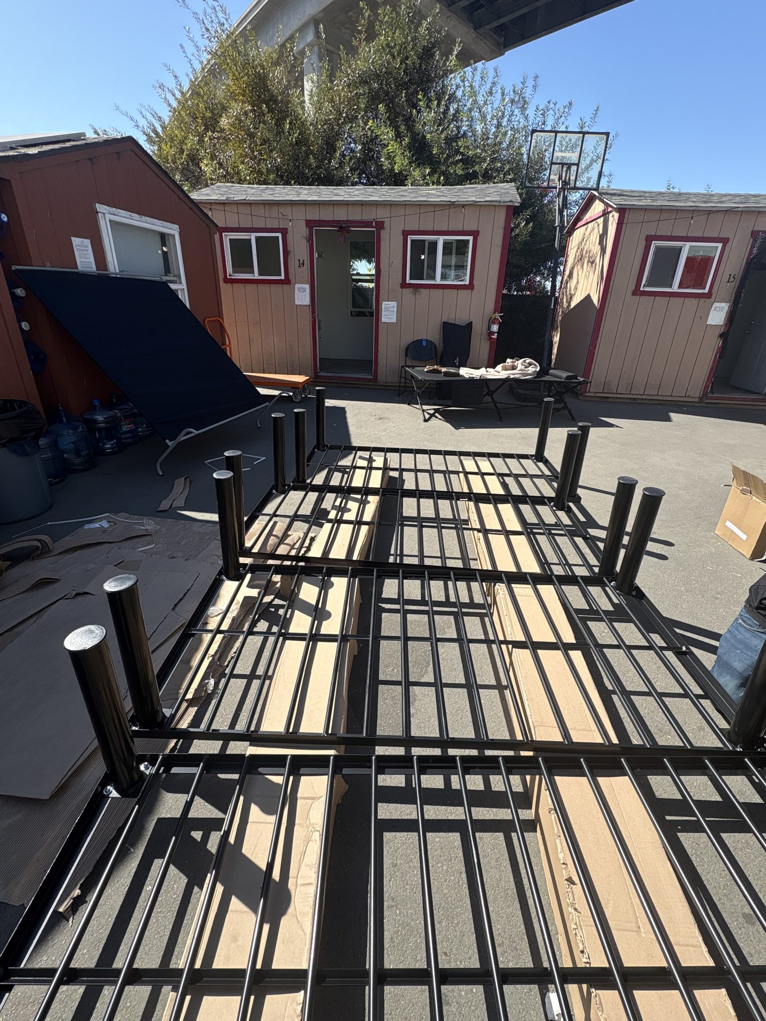 Platform bed frames staged outside the cabins
